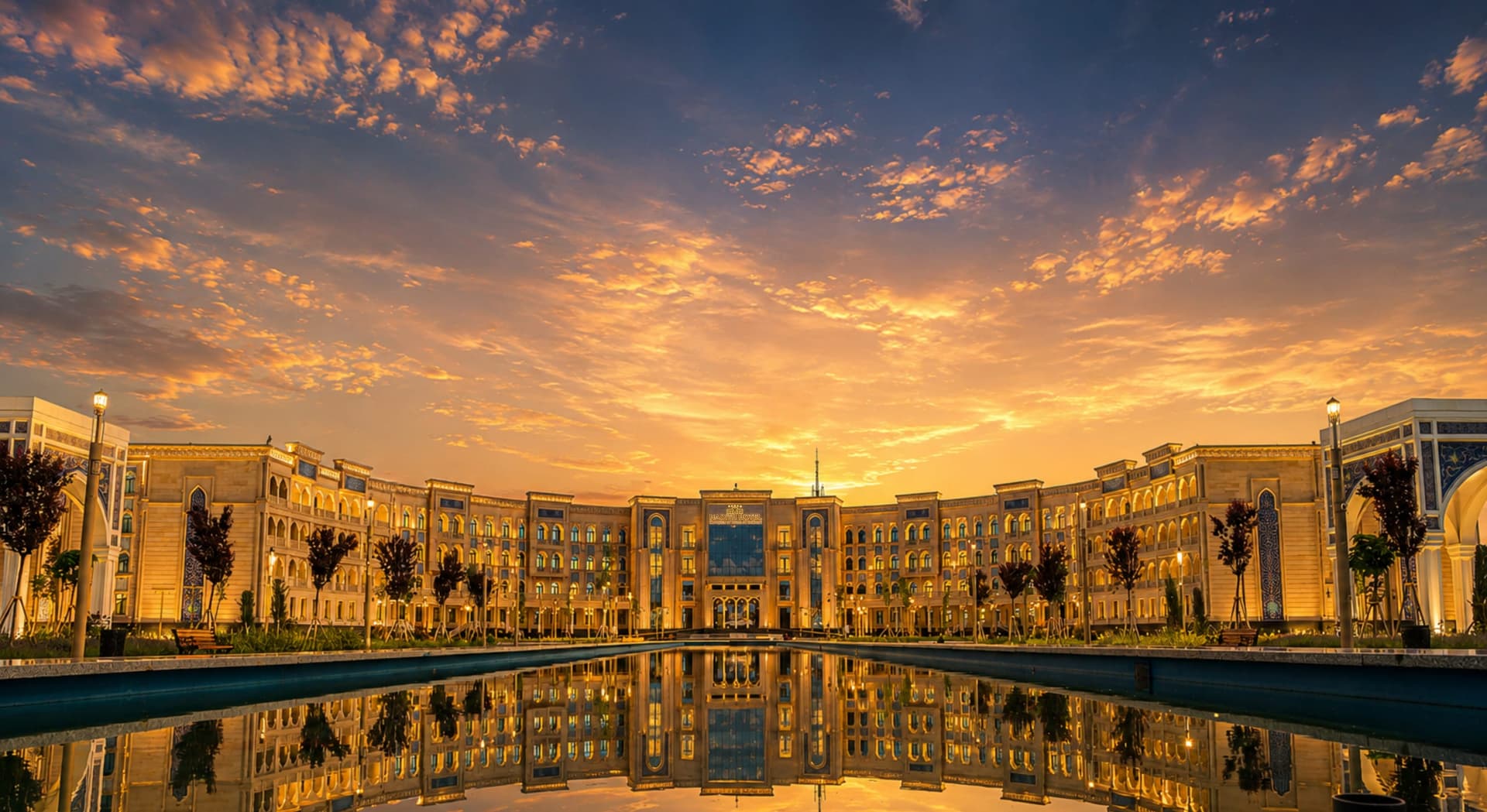 Hadith Hotel at golden hour, mirrored in its reflecting pool, Samarkand